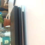 The Lenovo Yoga Book between an Apple MacBook Air and a Moleskine notebook